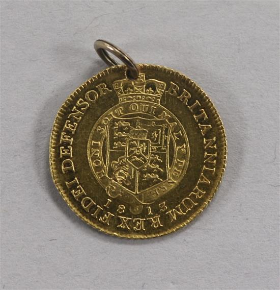 A George III gold half guinea, 1813, 4.4g gross, later pierced, with suspension loop